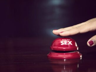 woman's hands press sex bell on a reception bell. concept about sex and eroticism